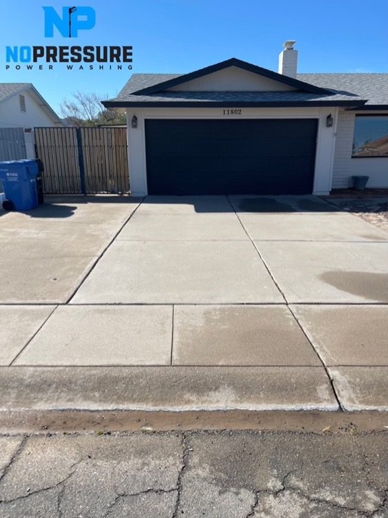 Freshly washed bright concrete driveway in front of a Gilbert home
